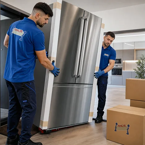 Doi hamali poartă un frigider inox pe cărucior prin apartament, ridicare frigider în apartament cu hamali